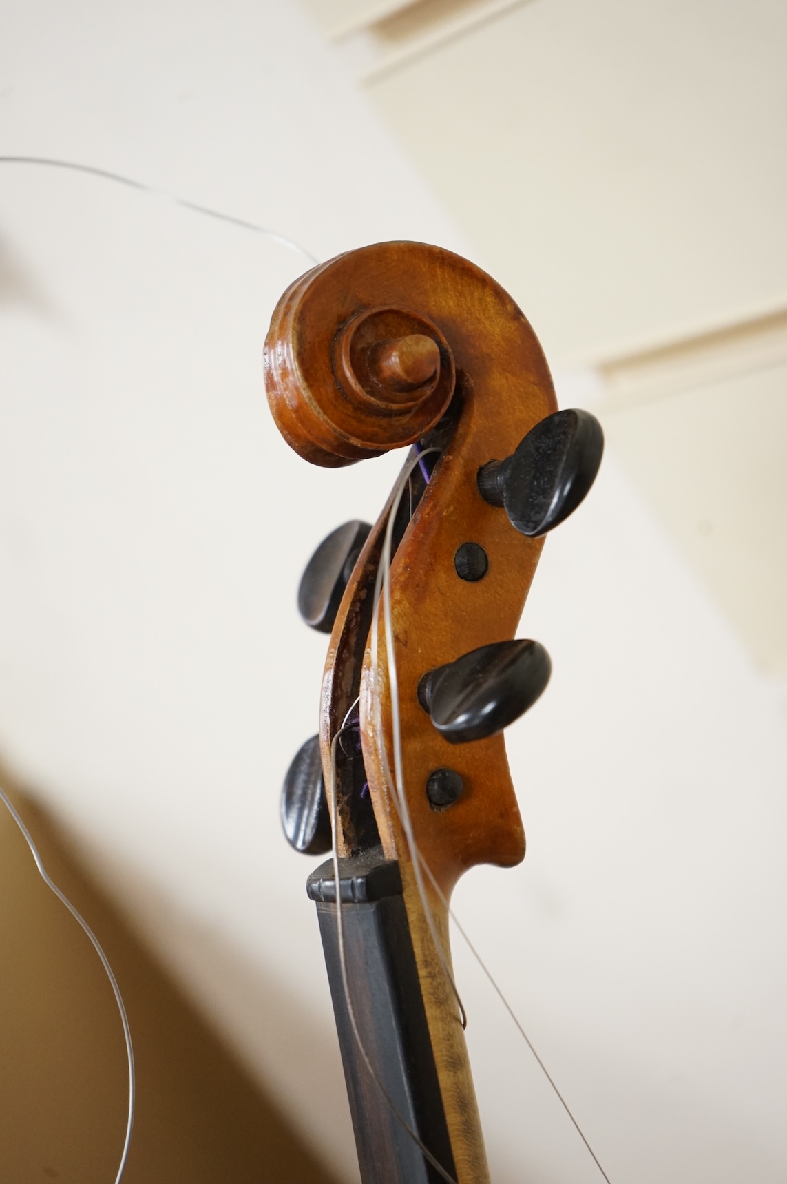 Four violins; a German Dresden violin, together with further two German violins, and a Saxony violin, three in cases or the remains of cases.